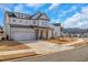 Two-story home showcasing the garage, an American flag, landscaping, and a concrete driveway at 335 Tillman Pass, Woodstock, GA 30188