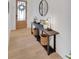 Hallway with light wood floors and decorative table at 335 Tillman Pass, Woodstock, GA 30188