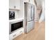 Kitchen with stainless steel refrigerator, microwave, white cabinets and a stairway in the background at 335 Tillman Pass, Woodstock, GA 30188