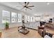 Bright living room boasts hardwood floors, large windows, and seamlessly connects to an open concept kitchen at 335 Tillman Pass, Woodstock, GA 30188