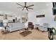 Bright living room featuring hardwood floors, neutral-colored sofas, and an open layout to the kitchen at 335 Tillman Pass, Woodstock, GA 30188