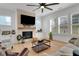 Inviting living room featuring a cozy fireplace, modern furnishings, and an abundance of natural light at 335 Tillman Pass, Woodstock, GA 30188