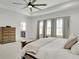 Bright main bedroom with tray ceiling and neutral colors, complemented by light from large windows at 335 Tillman Pass, Woodstock, GA 30188