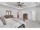 Bright main bedroom with neutral colors, tray ceiling, and wood furnishings at 335 Tillman Pass, Woodstock, GA 30188