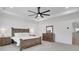 Primary bedroom featuring neutral walls, carpet, and wood furnishings, complemented by natural light from a large window at 335 Tillman Pass, Woodstock, GA 30188