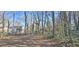 Large, partially wooded backyard with a chainlink fence and trees at 508 Jaywood Dr, Stone Mountain, GA 30083