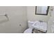 Powder room featuring a pedestal sink, toilet, and mirror at 508 Jaywood Dr, Stone Mountain, GA 30083