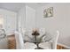 Cozy dining area featuring a glass-top table, white chairs, and a minimalist design, perfect for intimate meals at 6089 Mallory Rdg, Union City, GA 30291