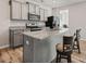 Stylish kitchen with gray cabinets, stainless steel appliances, and a granite countertop island with barstool seating at 6089 Mallory Rdg, Union City, GA 30291