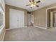 This bedroom has neutral walls, carpeting, a ceiling fan and an ensuite bathroom at 8885 Camp Tree Ct, Winston, GA 30187