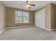 This bedroom features neutral walls, a large window for natural light, and a ceiling fan at 8885 Camp Tree Ct, Winston, GA 30187