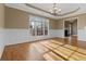 Dining room boasts hardwood floors, wainscoting, and a large window at 8885 Camp Tree Ct, Winston, GA 30187