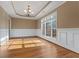 Bright dining room featuring hardwood floors, wainscoting, and a large window at 8885 Camp Tree Ct, Winston, GA 30187