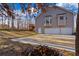 Rear exterior view of a house featuring a two car garage and deck at 8885 Camp Tree Ct, Winston, GA 30187