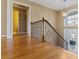 Foyer features hardwood floors, decorative railing, and natural light at 8885 Camp Tree Ct, Winston, GA 30187