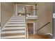 A graceful stairway with wooden banister with views into the living room is the focal point of this entry at 8885 Camp Tree Ct, Winston, GA 30187