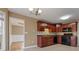 Charming kitchen featuring wooden cabinetry, backsplash, and modern appliances at 8885 Camp Tree Ct, Winston, GA 30187