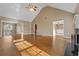 Open living room with hardwood floors, fireplace, and vaulted ceiling at 8885 Camp Tree Ct, Winston, GA 30187