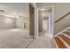 Spacious living room leading to a bright bathroom with a shower and wood-finished stairs at 8885 Camp Tree Ct, Winston, GA 30187