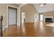 Large living room with a fireplace, hardwood floors, and bright windows at 8885 Camp Tree Ct, Winston, GA 30187