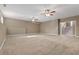 Expansive living room featuring neutral walls, plush carpet and contemporary ceiling fans at 8885 Camp Tree Ct, Winston, GA 30187