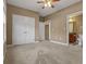 Cozy main bedroom featuring plush carpeting and a ceiling fan at 8885 Camp Tree Ct, Winston, GA 30187