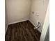 Utility closet with wood-look flooring and hookups for a washing machine and dryer at 256 Oakview Dr, Canton, GA 30114