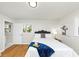 Bright bedroom featuring hardwood floors, a queen bed, and access to the bathroom at 3187 Clifton Church Rd, Atlanta, GA 30316