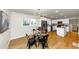 Bright dining area featuring a modern chandelier and a glass-top table, seamlessly connected to an updated kitchen at 3187 Clifton Church Rd, Atlanta, GA 30316