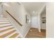 Bright entryway featuring wood floors, stairs, and a white door, with artwork enhancing the welcoming atmosphere at 3187 Clifton Church Rd, Atlanta, GA 30316