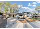 Charming two-story home with a manicured lawn and inviting entryway, painted white with black shutters at 3187 Clifton Church Rd, Atlanta, GA 30316