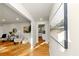 Bright hallway featuring wood floors, with artwork and a glimpse of the kitchen enhancing the welcoming atmosphere at 3187 Clifton Church Rd, Atlanta, GA 30316