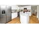 Bright kitchen boasts stainless steel appliances, an island with a granite countertop, and a subway tile backsplash at 3187 Clifton Church Rd, Atlanta, GA 30316