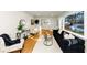 Inviting living room featuring hardwood floors, a large window, and comfortable furniture, with plants and artwork at 3187 Clifton Church Rd, Atlanta, GA 30316