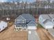 Aerial shot of a two-story home on a large lot with mature trees and a two car garage at 557 Clinton Dr, Temple, GA 30179