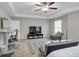 Bright bedroom suite features neutral décor, large windows, ceiling fan, and seating area with modern rug at 557 Clinton Dr, Temple, GA 30179