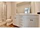 Bright bathroom featuring double sinks, a large mirror, and a walk-in shower at 2212 Whistler Ne Way, Lawrenceville, GA 30043