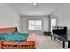 Bright bedroom with natural light, a comfortable bed, and a TV for entertainment at 2212 Whistler Ne Way, Lawrenceville, GA 30043