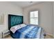 Neutral bedroom features a large window, carpet, and a tufted headboard at 2212 Whistler Ne Way, Lawrenceville, GA 30043
