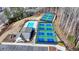Aerial view showcasing the pool and pickleball courts for residents' recreational enjoyment in a picturesque setting at 2212 Whistler Ne Way, Lawrenceville, GA 30043