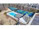 Aerial view of a pristine community pool with pickleball courts in background for enjoyable outdoor living at 2212 Whistler Ne Way, Lawrenceville, GA 30043