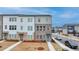New townhome with a well-manicured lawn and neutral exterior brick and white siding at 2212 Whistler Ne Way, Lawrenceville, GA 30043