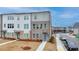 Townhome exterior with a manicured lawn and modern architectural details at 2212 Whistler Ne Way, Lawrenceville, GA 30043