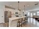 Modern eat-in kitchen open to the living room with stainless steel appliances and a large island at 2212 Whistler Ne Way, Lawrenceville, GA 30043