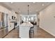 Modern eat-in kitchen open to the living room with stainless steel appliances and a large island at 2212 Whistler Ne Way, Lawrenceville, GA 30043