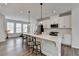 Bright kitchen features white cabinets, stainless steel appliances, quartz countertops, and a large center island with barstool seating at 2212 Whistler Ne Way, Lawrenceville, GA 30043