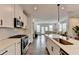 Modern eat-in kitchen open to the living room with stainless steel appliances and a large island at 2212 Whistler Ne Way, Lawrenceville, GA 30043