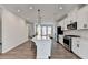 Bright kitchen features white cabinets, stainless steel appliances, quartz countertops, and a large center island with barstool seating at 2212 Whistler Ne Way, Lawrenceville, GA 30043