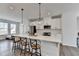 Bright kitchen features white cabinets, stainless steel appliances, quartz countertops, and a large center island with barstool seating at 2212 Whistler Ne Way, Lawrenceville, GA 30043