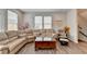 Open living room with a large sectional sofa, wood floors, a comfy chair and lots of natural light at 2212 Whistler Ne Way, Lawrenceville, GA 30043